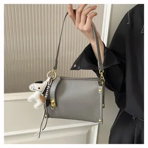 Chic gray shoulder bag for women, stylish crossbody bag with cute horse charm and wide strap.