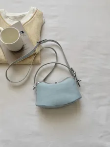 Light blue canvas shoulder bag detail view with fine strap and metallic clasp on clean background