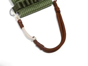 Close-up of green grid outdoor tactical bag strap, durable nylon paracord design.