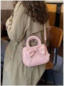 Pink bow handbag stylish shoulder bag with round handle for women fashion daily use.