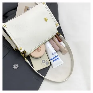 White crossbody shoulder bag detail view showing large capacity and nice wide strap design.