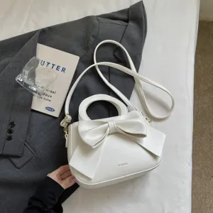 Chic white crossbody bag with elegant bowknot design, stylish shoulder handbag for women.