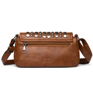 Retro brown women crossbody bag detail showing metallic studs and zippered back pocket design.