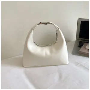 Detailed view of white minimalist shoulder handbag with metallic buckle, elegant underarm hobo style.