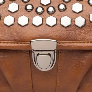Brown leather shoulder bag detail, featuring silver metal lock and stylish rivet hardware.