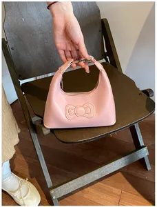 Pink shoulder bag for women, cute bow underarm bag, stylish PU leather handbag for daily use.