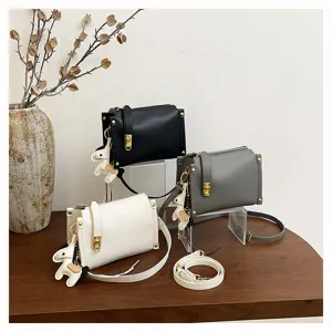 Stylish small crossbody bag with wide strap, minimalist PU leather box design and cute horse charm.