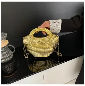 Gold metallic acrylic dumpling bag detail showcasing shiny beaded texture and chain strap.