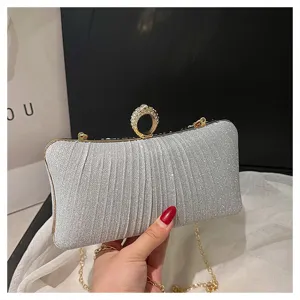 Silver glitter evening clutch bag with sparkling rhinestone ring clasp and metal chain strap.