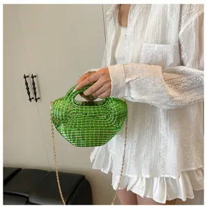 Detailed view of glossy green acrylic beaded dumpling handbag featuring elegant gold chain strap.