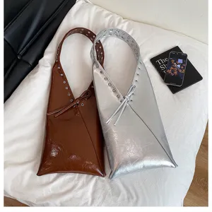 Women vintage PU leather shoulder bag underarm tote purse with metal eyelet and bow decor.