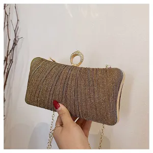 Elegant gold glitter evening clutch bag with sparkly rhinestone ring clasp and chain strap.