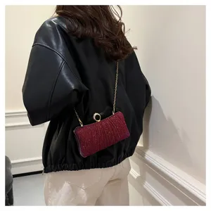 Sparkling rhinestone evening clutch bag for women with gold chain and round clasp detail.