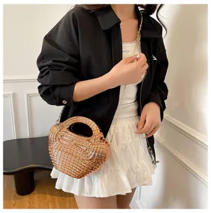 Glossy metallic woven acrylic dumpling shoulder bag with chic chain strap for fashionable women.