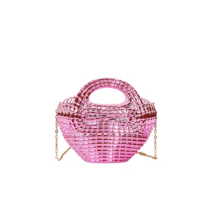 Glossy pink acrylic handbag detail view, showing the woven texture and metal chain strap.