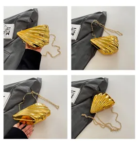 Gold acrylic shell clutch bag detail view, unique design shoulder chain handbag accessories.
