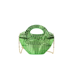 Details of the glossy green acrylic dumpling handbag with chain strap, modern fashion style.