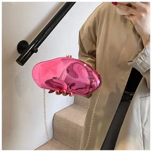 Pink metallic acrylic clutch bag with gold chain strap, stylish irregular evening bag.