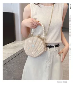 Stylish pearl handle shell clutch bag with glitter finish and chain strap for women evening.