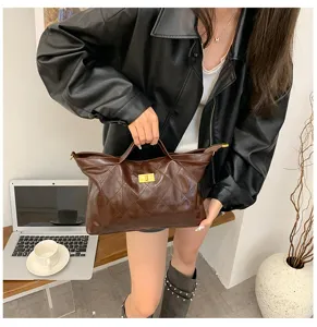 Detailed shot of retro brown quilted tote bag, showing metallic turn-lock and spacious interior.