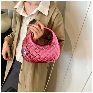 Pink quilted acrylic round handle evening bag with chain strap detail showing texture.