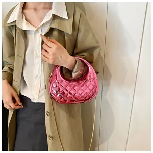 Close-up detail view of the glossy pink quilted acrylic evening bag with chic chain strap.
