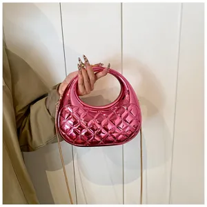 Pink quilted acrylic handbag detail showing glossy metallic finish and sleek chain strap for women.