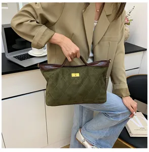 Green suede patchwork shoulder bag detail showing vintage design, gold lock, and stylish look.