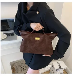 Brown suede shoulder bag detail, vintage slouchy tote purse with gold turn lock closure.