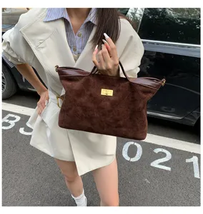 Vintage brown suede handbag for women, casual tote bag with chic lock design and top handle.
