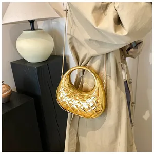 Metallic gold quilted acrylic box bag detail, elegant chain crossbody evening bag.