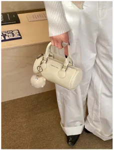 Cute Boston handbag detail with plush charm, stylish women shoulder bag for daily commute.