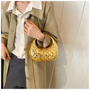 Gold metallic quilted acrylic evening bag detail showcasing exquisite luxury texture.