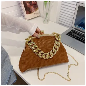 Detailed shot of a brown pleated clutch bag with chunky gold chain and kiss-lock closure.