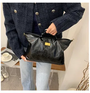 Detail view of casual retro black quilted tote bag with stylish gold turn-lock closure.