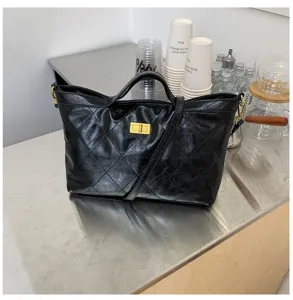 Black quilted tote shoulder bag with metallic turn lock closure, casual daily handbag style.