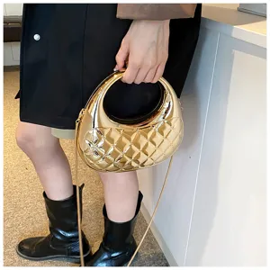 Detail view of the metallic gold quilted acrylic evening box bag showcasing its sleek texture.