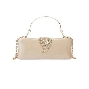 Elegant champagne gold evening clutch with metal chain strap and hollow leaf clasp for women.
