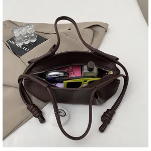 Dark brown nappa leather tote bag with knotted handle and spacious interior design for women.