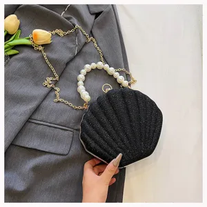 Black glitter shell evening bag with elegant pearl handle and metal chain shoulder strap for women.