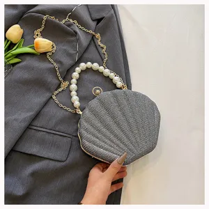 Women shell evening bag with pearl handle and chain strap stylish crossbody bag for party.