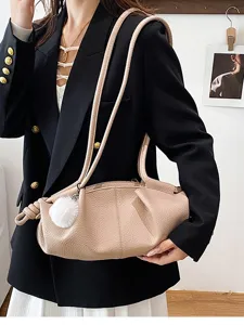 Stylish pleated leather shoulder bag for women, elegant dumpling handbag with knot details.