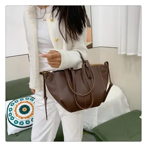 Close-up of stylish brown tote bucket bag, chic daily handbag for fashion women and casual wear.