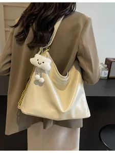 Women soft leather shoulder bag casual crossbody dumpling handbag with cute plush cloud charm.