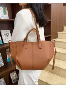 Stylish brown PU leather tote bag for women, perfect for daily commuting and shopping trips.