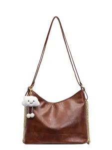 Stylish brown patchwork shoulder bag for women, soft leather hobo bag with cute cloud charm.