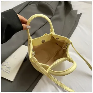 Stylish minimalist yellow bucket bag, PU leather crossbody handbag with shoulder strap.