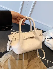 White leather bucket handbag for women, casual crossbody shoulder bag with cute bow detail.