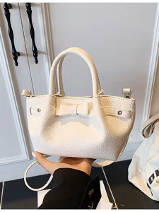 Stylish casual white bucket handbag for women, featuring bow detail and shoulder strap.