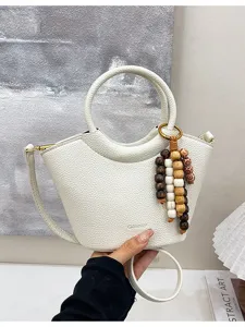 Trendy white bucket handbag for women, stylish leather shoulder crossbody bag with wooden beads.